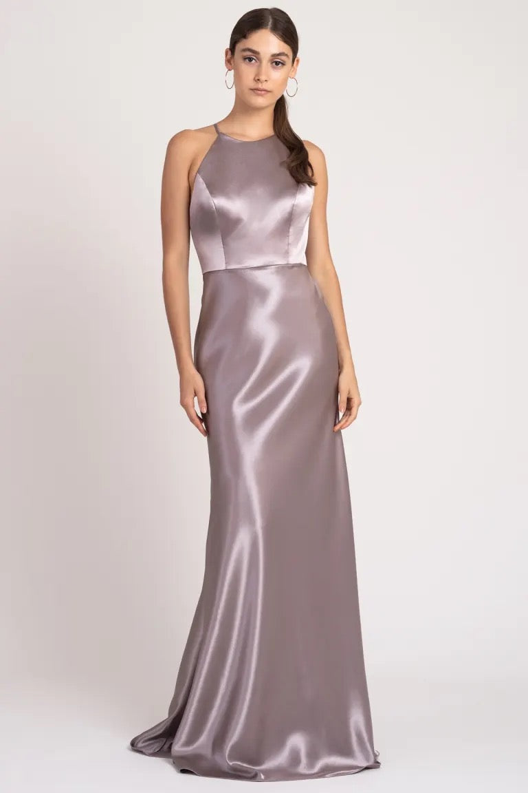 Woman posing in a sleeveless Alessia bridesmaid dress by Jenny Yoo with a high neckline from Bergamot Bridal.