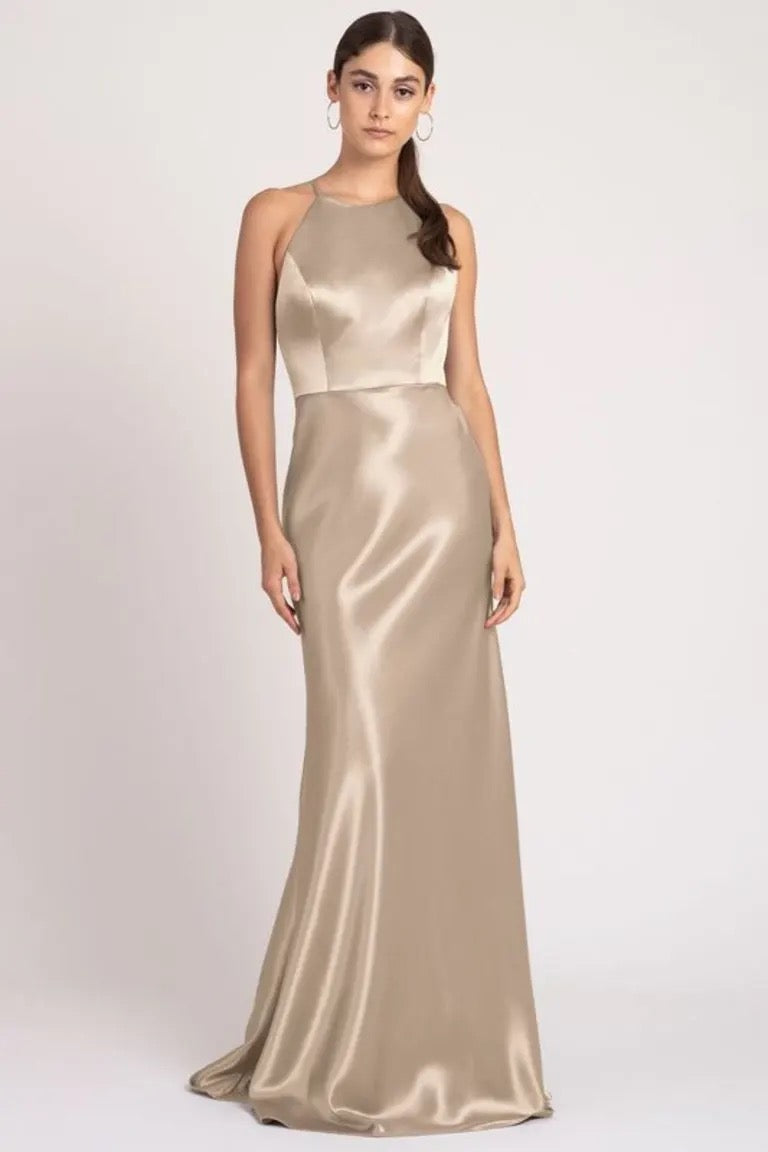 Woman posing in a sleek, satin back crepe Alessia - Bridesmaid Dress by Jenny Yoo with a high neckline by Bergamot Bridal.