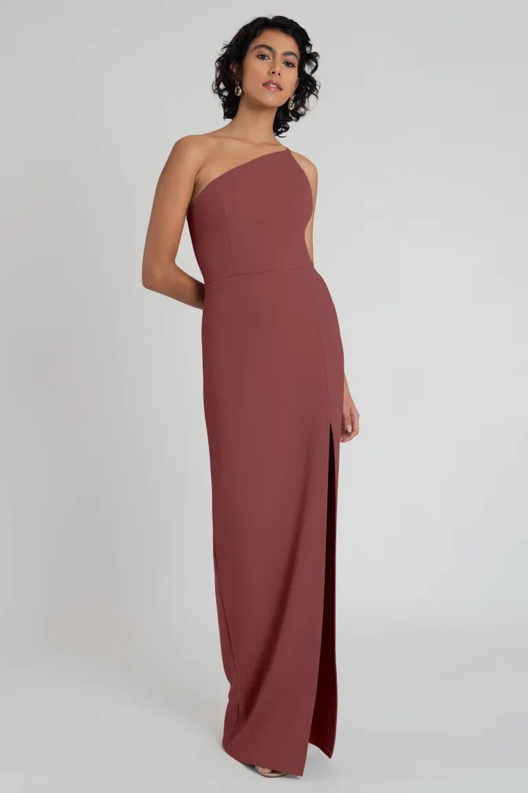 Woman in an elegant, one-shoulder neckline Aubrey bridesmaid dress by Jenny Yoo made of knit crepe.