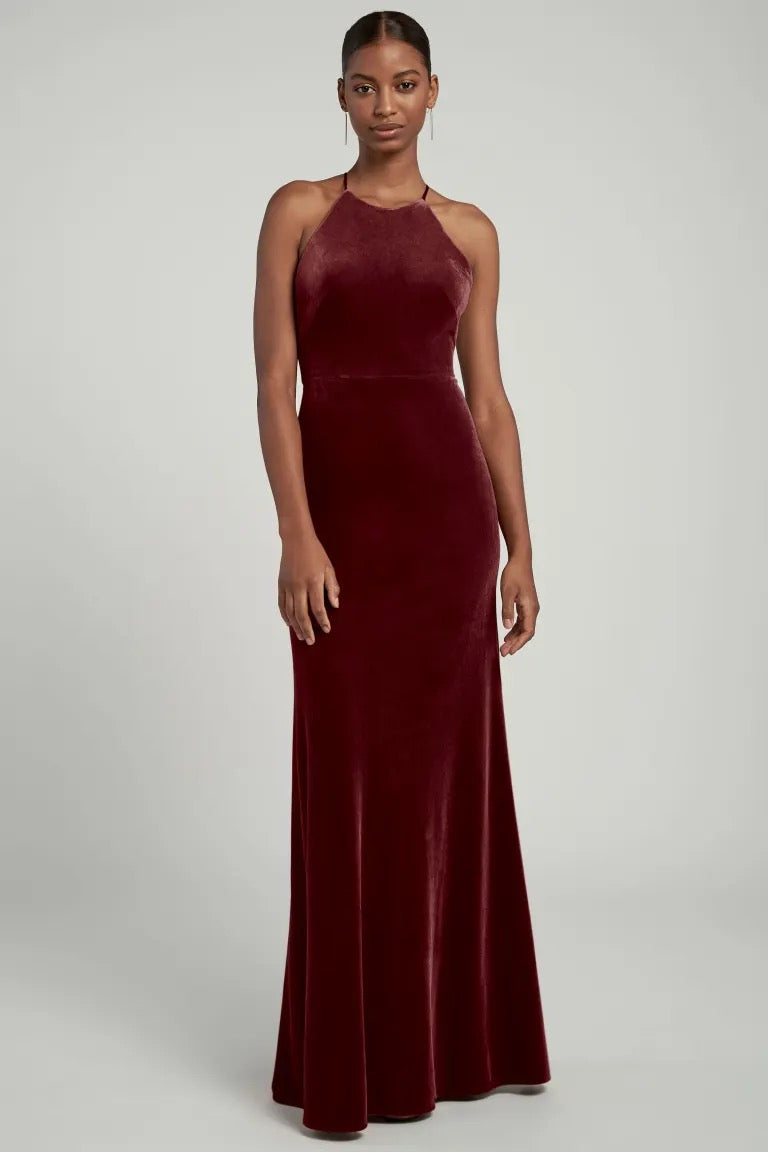 Woman in a Bailey - Bridesmaid Dress by Jenny Yoo velvet evening gown with a halter neckline from Bergamot Bridal.