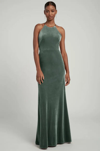Woman modeling an elegant Bailey velvet dress for the bridal party with a halter neckline by Jenny Yoo at Bergamot Bridal.