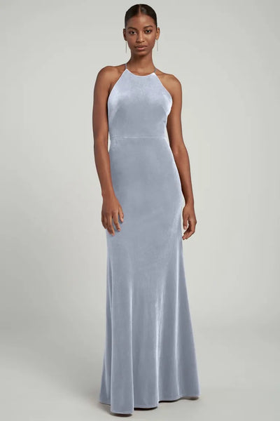 Woman standing in a Bailey Bridesmaid Dress by Jenny Yoo with a halter neckline from Bergamot Bridal.