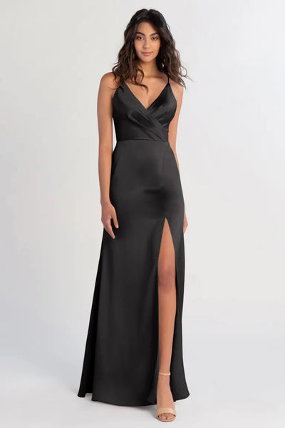 A woman posing in a Beckette bridesmaid dress by Jenny Yoo with a thigh-high slit from Bergamot Bridal.