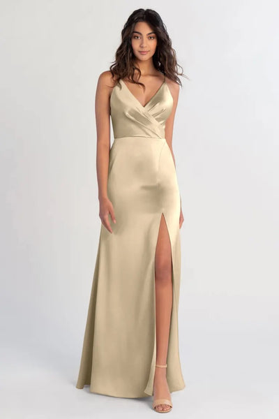 Woman in an elegant Beckette bridesmaid dress by Jenny Yoo with a thigh-high slit and a V-neck by Bergamot Bridal.