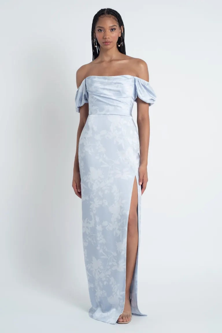 Woman in a Blakely - Jenny Yoo Bridesmaid Dress by Bergamot Bridal, an off-the-shoulder, corsage printed satin gown with a thigh-high slit.