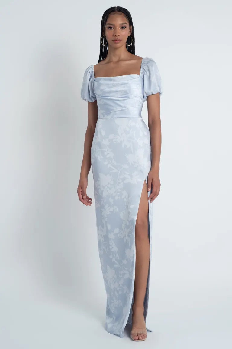 Woman in an elegant Corsage printed satin Jenny Yoo Bridesmaid Dress with a floral pattern and a high slit from Bergamot Bridal.