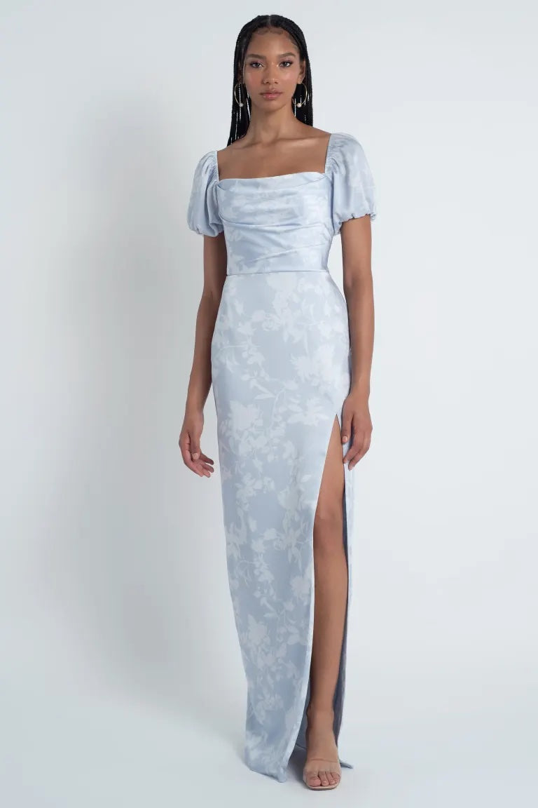 Woman in an elegant Corsage printed satin Jenny Yoo Bridesmaid Dress with a floral pattern and a high slit from Bergamot Bridal.