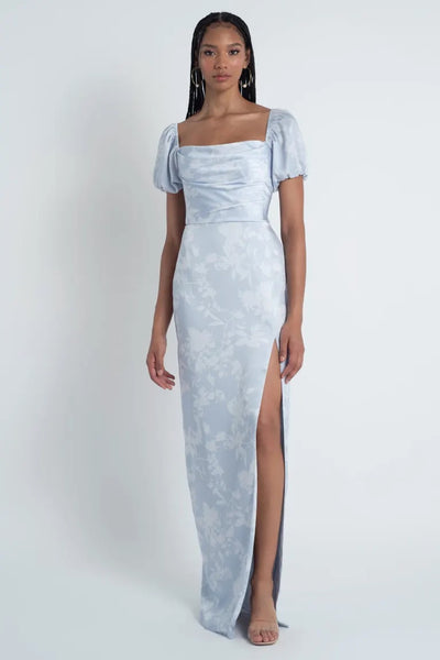 Woman in an elegant Corsage printed satin Jenny Yoo Bridesmaid Dress with a floral pattern and a high slit from Bergamot Bridal.