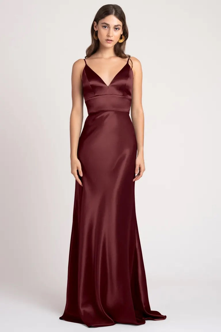 Woman in an elegant Brenna - Bridesmaid Dress by Jenny Yoo evening gown with a cummerbund waist from Bergamot Bridal.