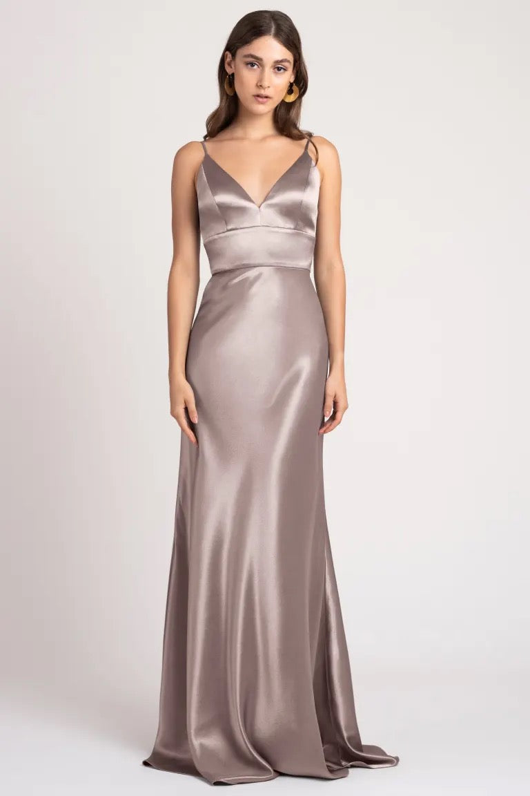 Woman in an elegant Brenna - Bridesmaid Dress by Jenny Yoo made from satin back crepe fabric.
