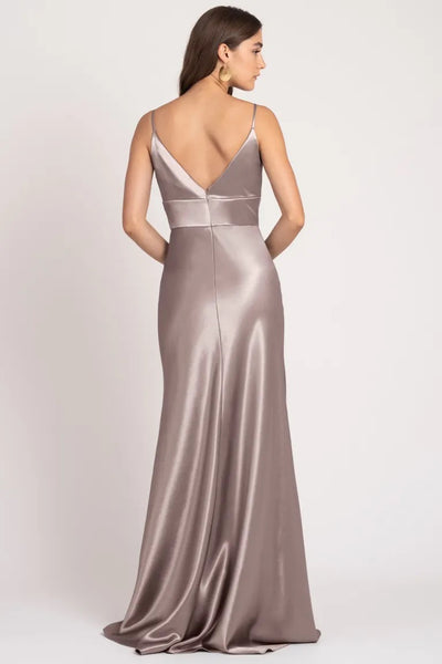 Woman in a Brenna - Bridesmaid Dress by Jenny Yoo dress made from satin back crepe fabric, viewed from behind.
