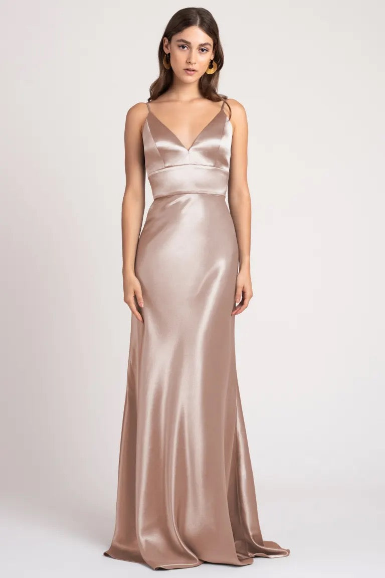 Woman wearing an elegant Brenna - Bridesmaid Dress by Jenny Yoo crafted from satin back crepe fabric.