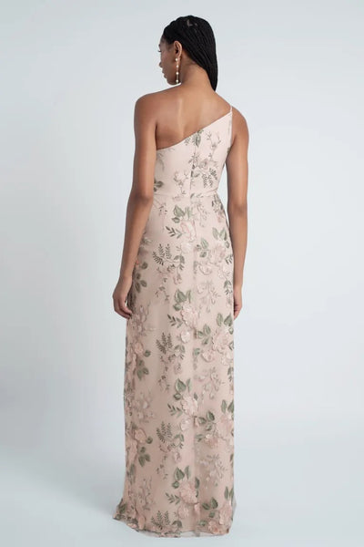 Woman in an enchanted floral embroidered tulle Jenny Yoo Bridesmaid Dress with a one-shoulder neckline, viewed from the back, from Bergamot Bridal.