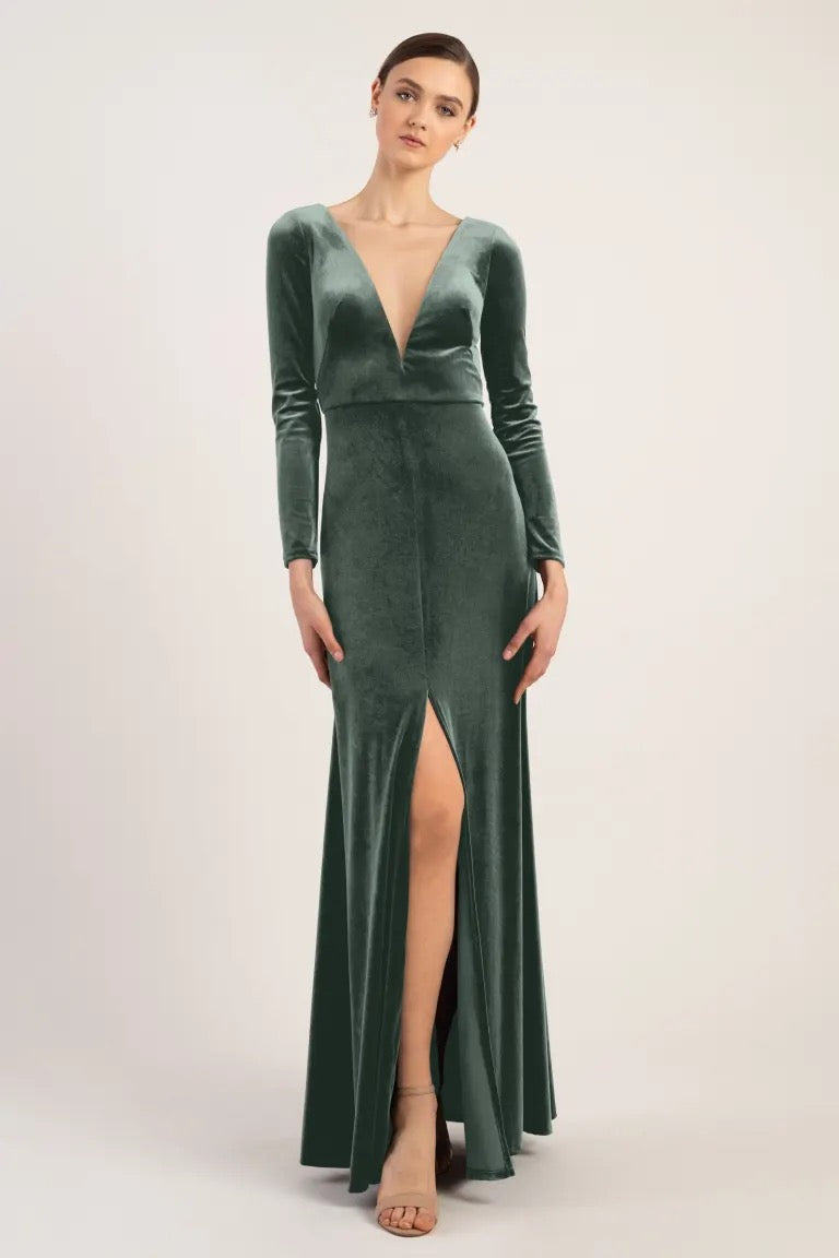Woman modeling a luxe velvet Malia - Bridesmaid Dress by Jenny Yoo with a slit from Bergamot Bridal.