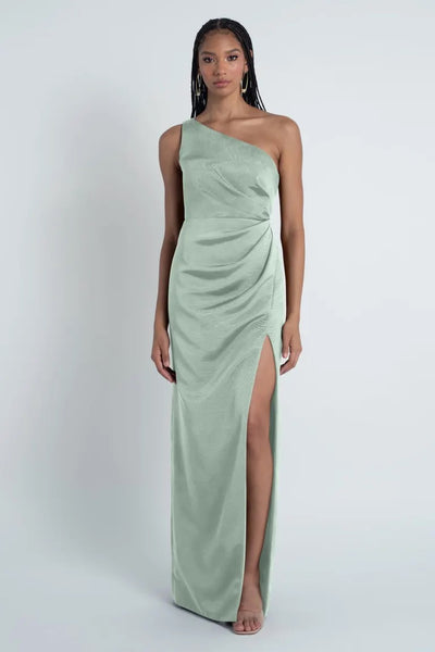 Woman posing in a Carolina - Jenny Yoo Bridesmaid Dress crafted from Luxe Faille fabric, featuring a one-shoulder neckline and a thigh-high slit.