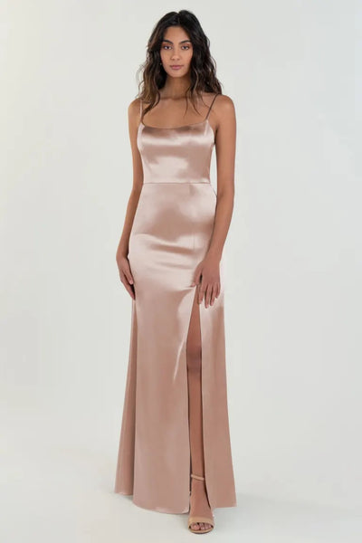 Woman posing in an elegant Chase - Bridesmaid Dress by Jenny Yoo evening gown with a thigh-high slit from Bergamot Bridal.