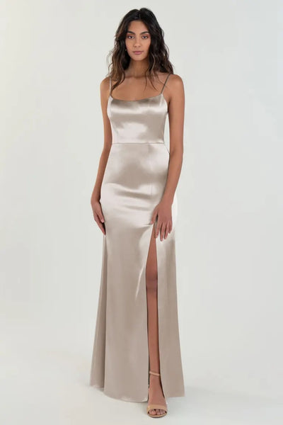 Woman posing in an elegant Chase - Bridesmaid Dress by Jenny Yoo in satin back crepe with a thigh-high slit from Bergamot Bridal.