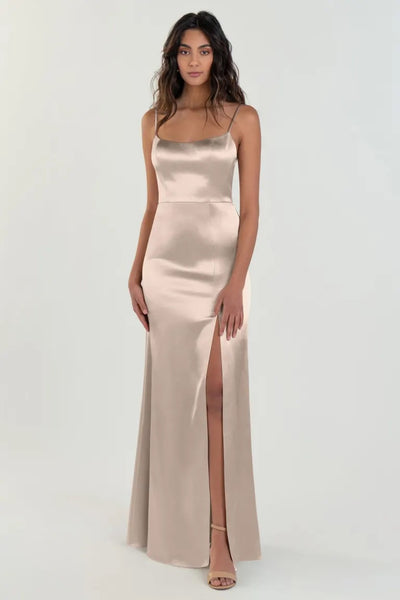 Woman posing in a Chase - Bridesmaid Dress by Jenny Yoo from Bergamot Bridal, a satin back crepe evening gown with a thigh-high slit.