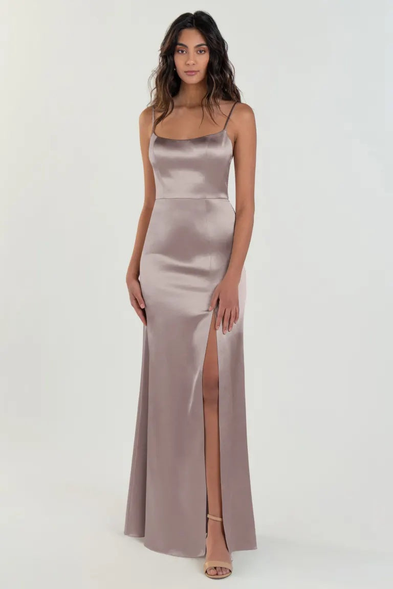 Woman posing in an elegant Chase - Bridesmaid Dress by Jenny Yoo with a thigh-high slit from Bergamot Bridal.