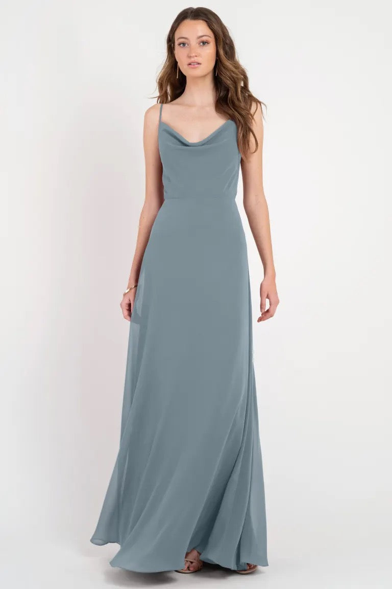 Woman in a flowing grey Colby - Jenny Yoo bridesmaid dress with a cowl neckline from Bergamot Bridal.