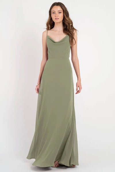 Woman in an elegant olive green Colby - Jenny Yoo Bridesmaid Dress with a cowl neckline from Bergamot Bridal.