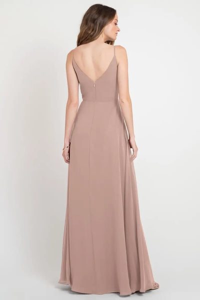 Woman in an elegant Colby - Jenny Yoo bridesmaid dress from Bergamot Bridal with a plunging back.