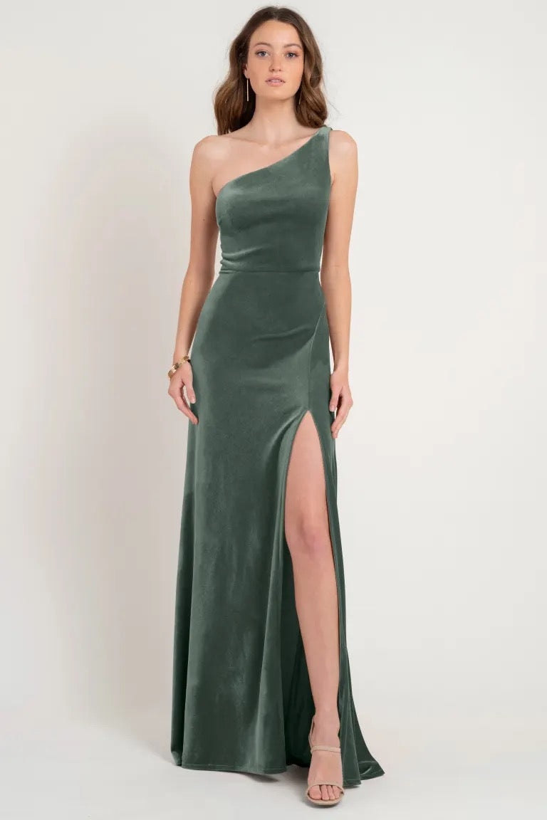 Woman posing in an elegant Cybill - Bridesmaid Dress by Jenny Yoo from Bergamot Bridal with a high slit.