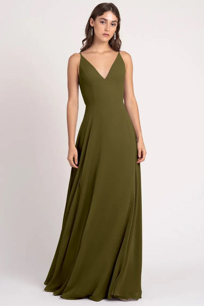 Woman in a Dani - Bridesmaid Dress by Jenny Yoo with a v-neckline and sharp tailoring by Bergamot Bridal.