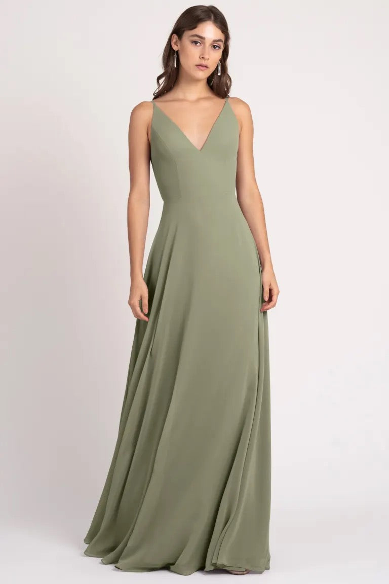 Woman in an elegant olive green evening gown featuring a keyhole back, the Dani - Bridesmaid Dress by Jenny Yoo from Bergamot Bridal.