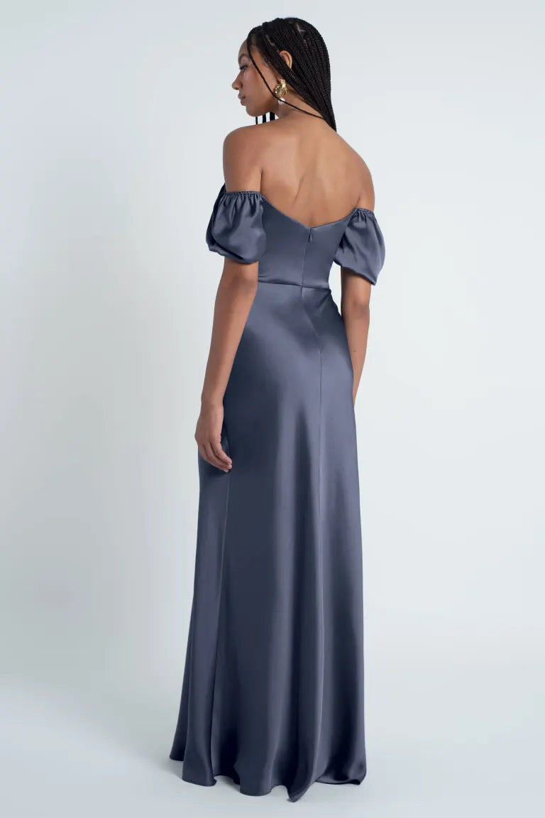 Woman in an elegant off-shoulder Jenny Yoo Bridesmaid Dress with puff sleeves, viewed from the back.