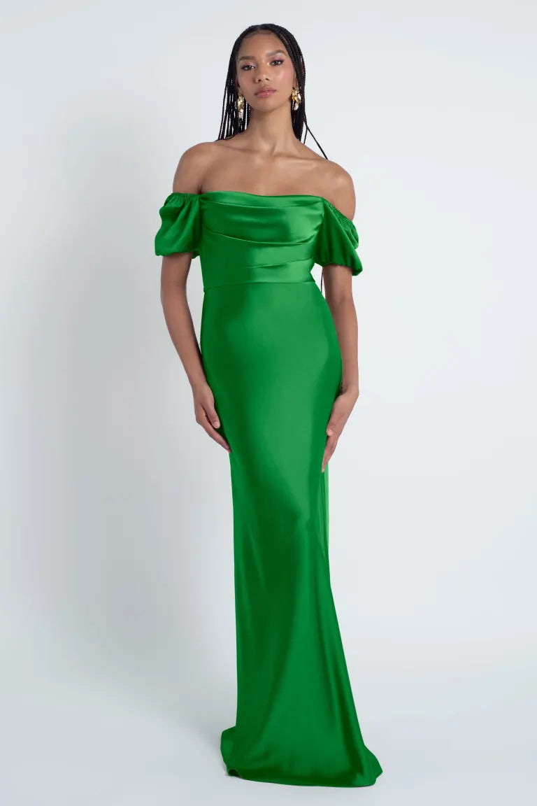Woman in an off-the-shoulder green Jenny Yoo Bridesmaid Dress with a bias-cut skirt from Bergamot Bridal.