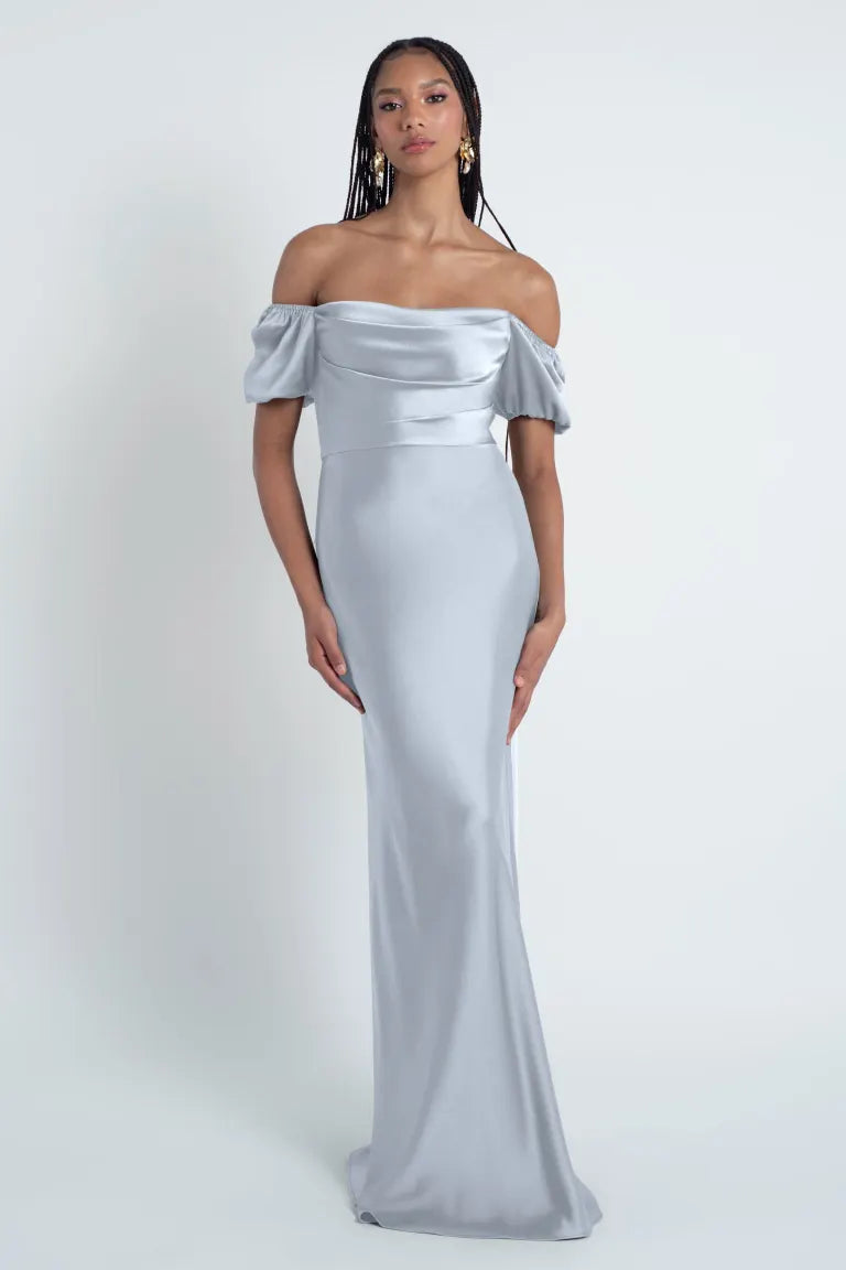 Woman in an elegant Jenny Yoo Bridesmaid Dress in off-shoulder gray gown with a bias cut skirt from Bergamot Bridal.