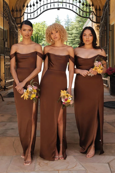 Three women in matching Sawyer - Bridesmaid Dresses by Jenny Yoo with off the shoulder sleeves, holding bouquets. Brand Name: Bergamot Bridal