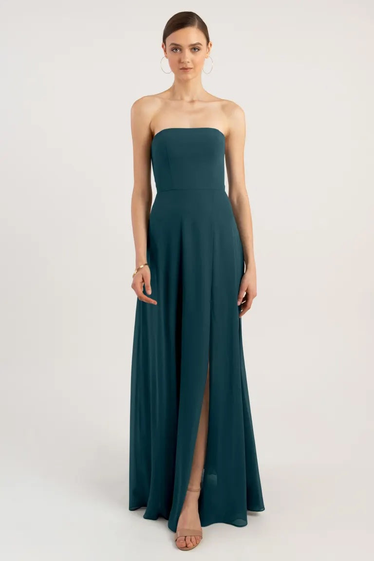 Woman in an elegant strapless teal Essie - Bridesmaid Dress by Jenny Yoo with a thigh-high slit from Bergamot Bridal.