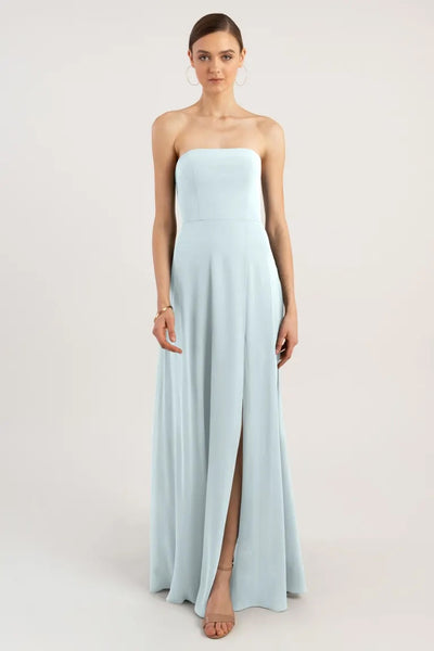 Woman in a light blue Essie - Bridesmaid Dress by Jenny Yoo with a strapless neckline and a slit from Bergamot Bridal.