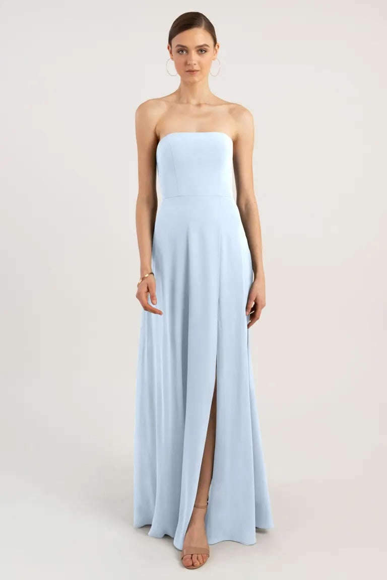 Woman in a light blue strapless Essie bridesmaid dress by Jenny Yoo with a slit from Bergamot Bridal.