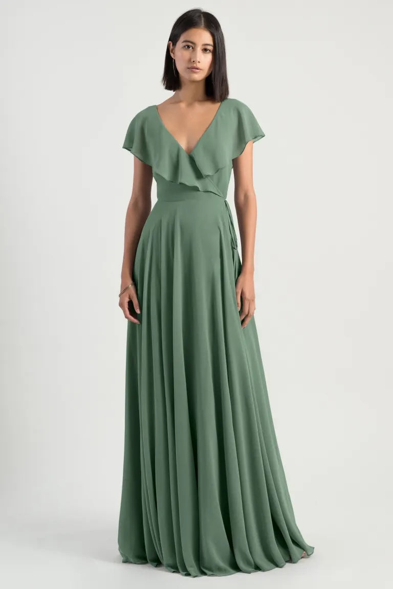 Woman posing in a romantic Faye - Bridesmaid Dress by Jenny Yoo with flutter sleeves and a v-neckline from Bergamot Bridal.