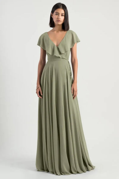 Woman in an elegant olive green chiffon wrap dress with a v-neckline - Faye Bridesmaid Dress by Jenny Yoo at Bergamot Bridal
