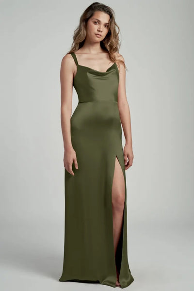 A woman posing in an elegant olive green satin bridesmaid dress with a cowl neckline, the Gina - Bridesmaid Dress by Jenny Yoo from Bergamot Bridal.