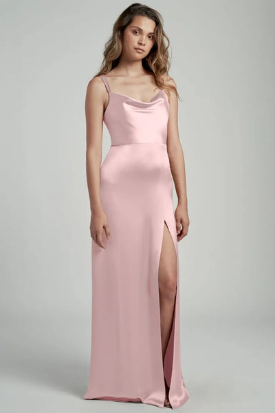 Woman in a pink satin Gina bridesmaid dress by Jenny Yoo with a thigh-high slit and cowl neckline from Bergamot Bridal.