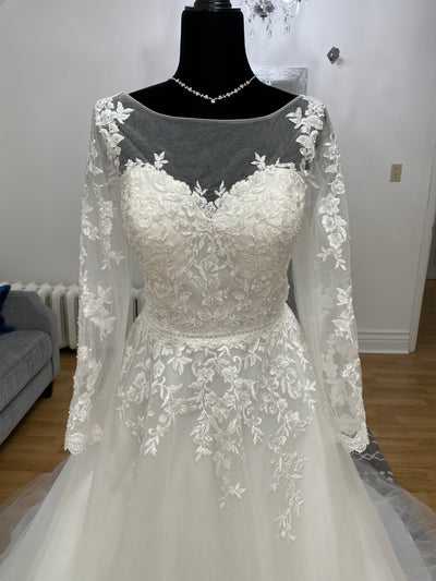 Bridalane A-line Lace Long Sleeve Dress by Bergamot Bridal on a mannequin featuring long lace sleeves, a detailed floral bodice, and an illusion high neckline.