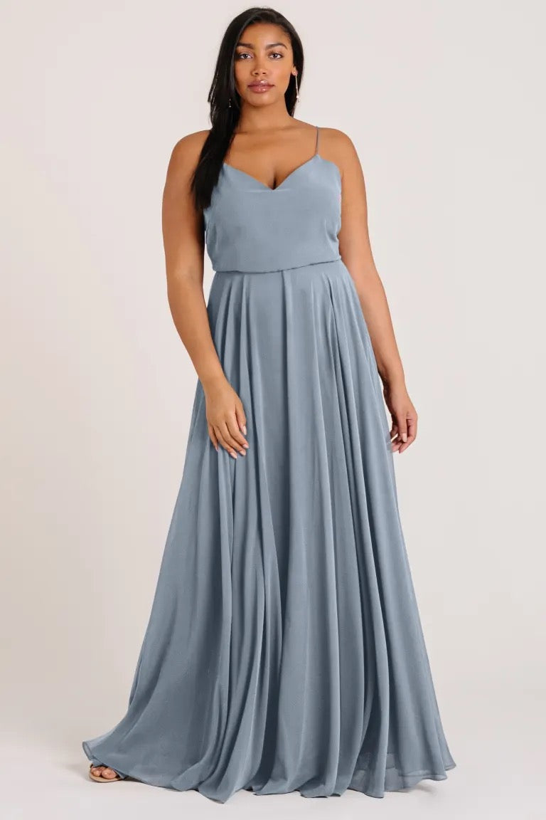 Woman wearing a blue Inesse - Bridesmaid Dress by Jenny Yoo evening gown with a V-neck from Bergamot Bridal.