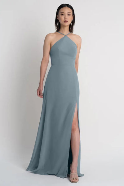 Woman posing in an elegant, single-shoulder Ingrid - bridesmaid dress by Jenny Yoo with a high slit from Bergamot Bridal.