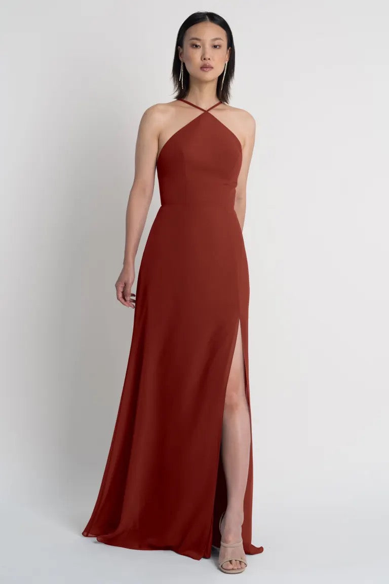 Woman in an elegant Ingrid bridesmaid dress by Jenny Yoo with a high side slit from Bergamot Bridal.