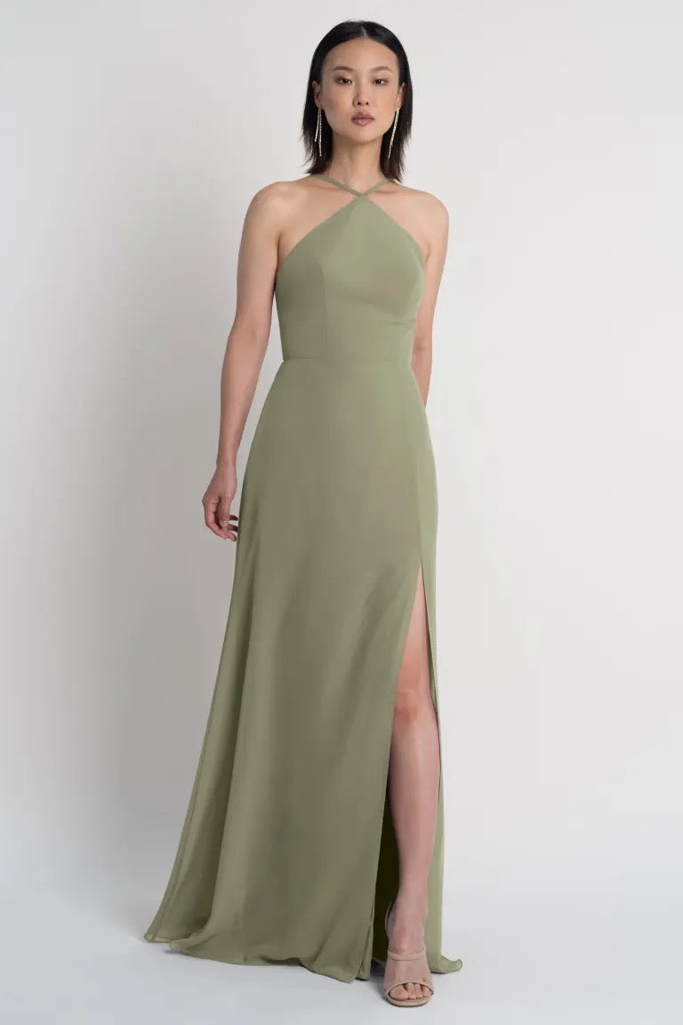 Woman in an olive green Ingrid bridesmaid dress by Jenny Yoo with a high slit from Bergamot Bridal.