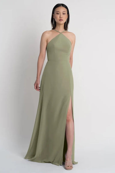 Woman in an olive green Ingrid bridesmaid dress by Jenny Yoo with a high slit from Bergamot Bridal.