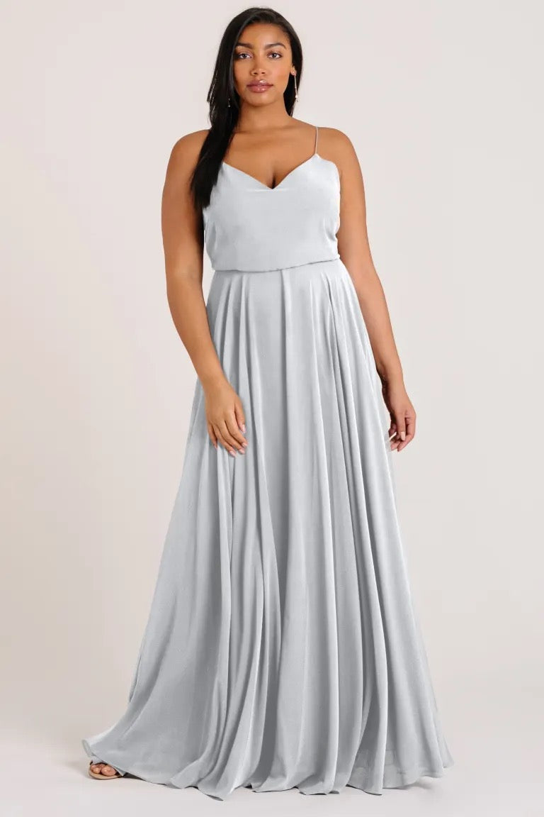 Woman in a flowing Inesse - Bridesmaid Dress by Jenny Yoo chiffon maxi dress with a V-neck from Bergamot Bridal.