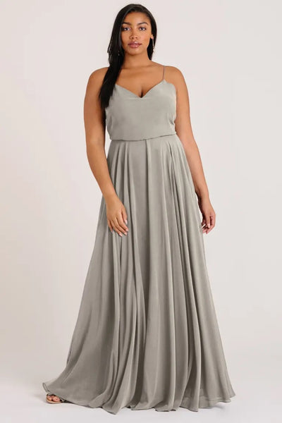 Woman modeling a floor-length Inesse chiffon bridesmaid dress by Jenny Yoo with a sleeveless top and V-neck from Bergamot Bridal.