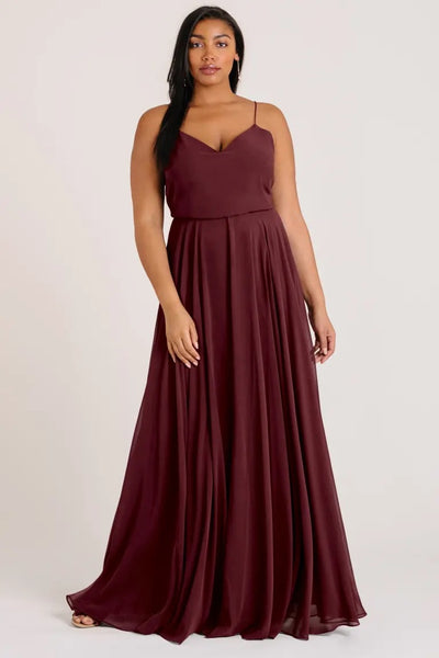 Woman in an elegant burgundy Inesse bridesmaid dress by Jenny Yoo with a V-neck from Bergamot Bridal.