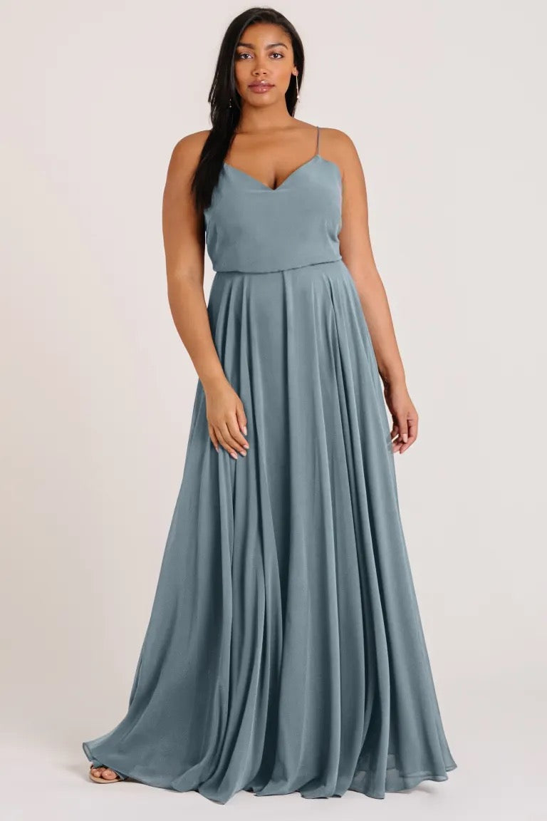 Woman in a flowing blue Inesse bridesmaid dress by Jenny Yoo with a V-neck from Bergamot Bridal.